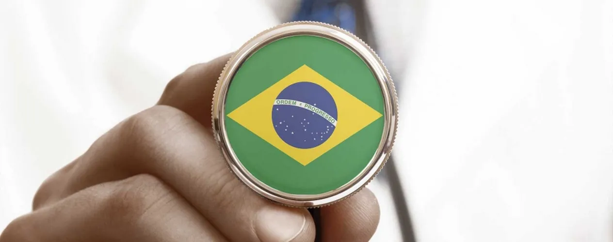 Man holding a pendant showing the symbol for Brazil