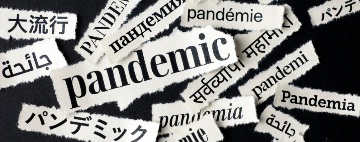 "Pandemic" written in different international languages on slips of paper