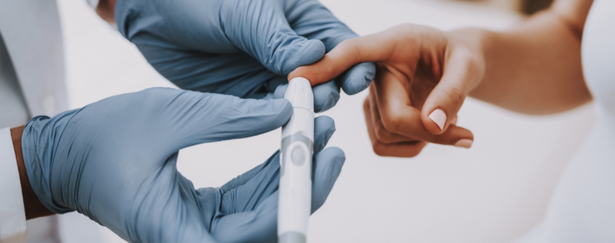 Doctor checking blood sugar levels of patient