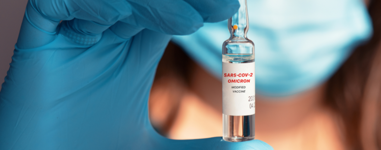 Gloved hand holding vial labeled "SARS-COV-2 OMICRON"