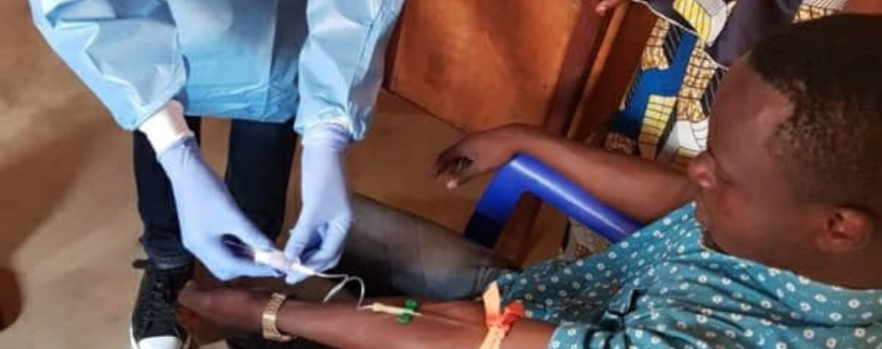 A team member from the Democratic Republic of Congo’s National Institute of Biomedical Research takes a blood sample from a vaccinated man in North Kivu Province.