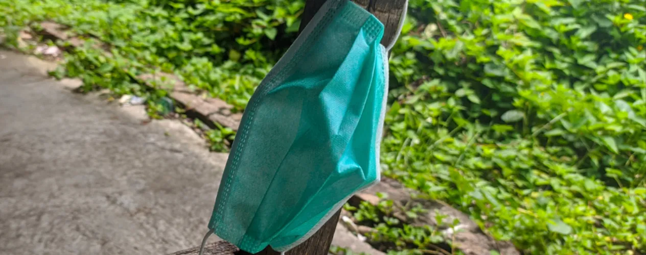 Mask hanging on wooden pole