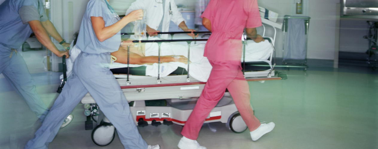 ER doctors rushing a hospital bed