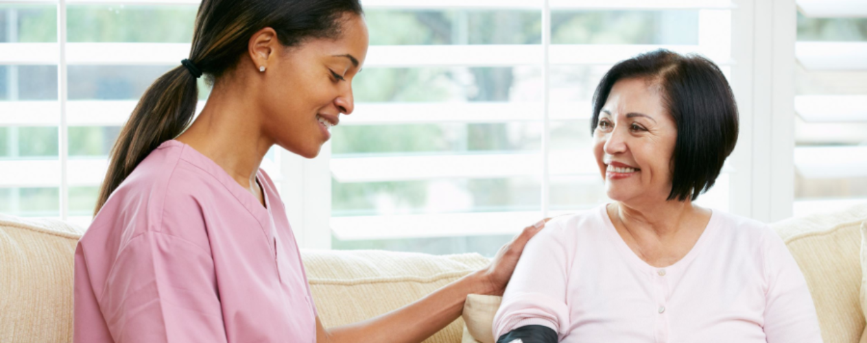 Nurse taking blood pressure of patient