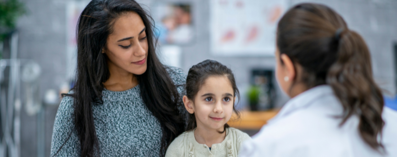 Mother and daughter talking to doctor