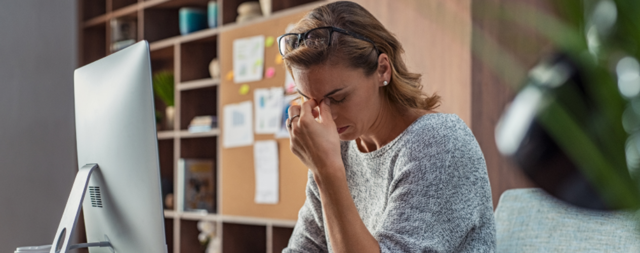 Stressed individual holding the bridge of their nose