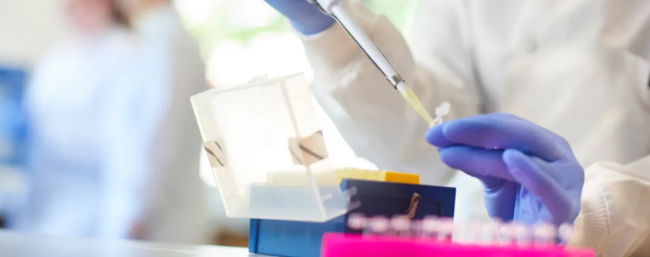 Scientist using a pipette in a lab