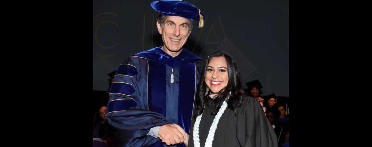 Dr. Steve Wallace shaking hands with a graduating student