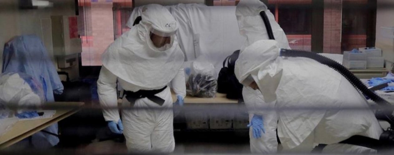 Men in disinfectant suits