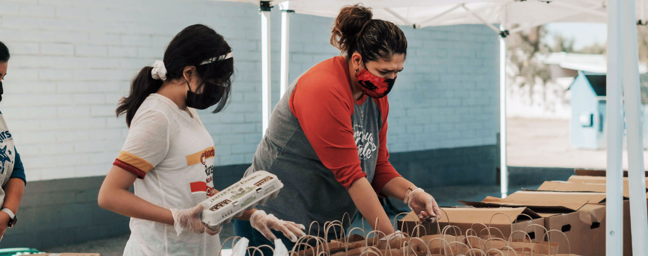 Two women packing lunches