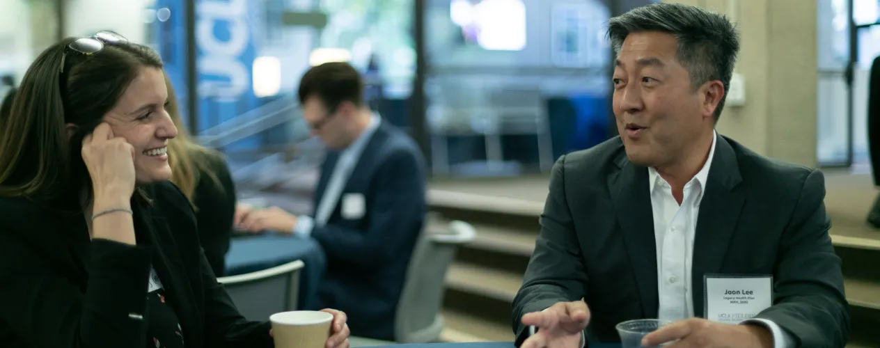 graduates in conversation at networking event