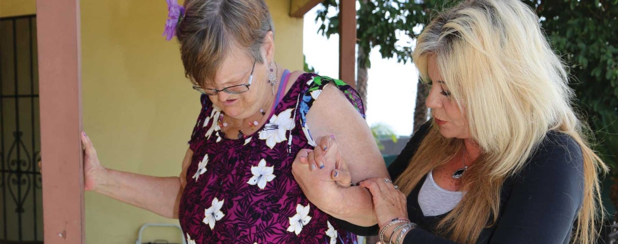 Elderly woman getting assisted