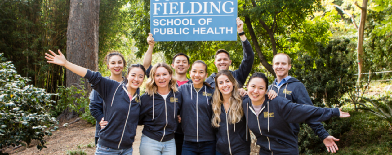 Students holding up a sign that says UCLA FSPH