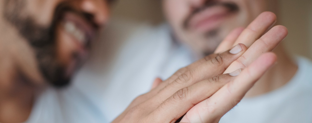 Two men holding hands