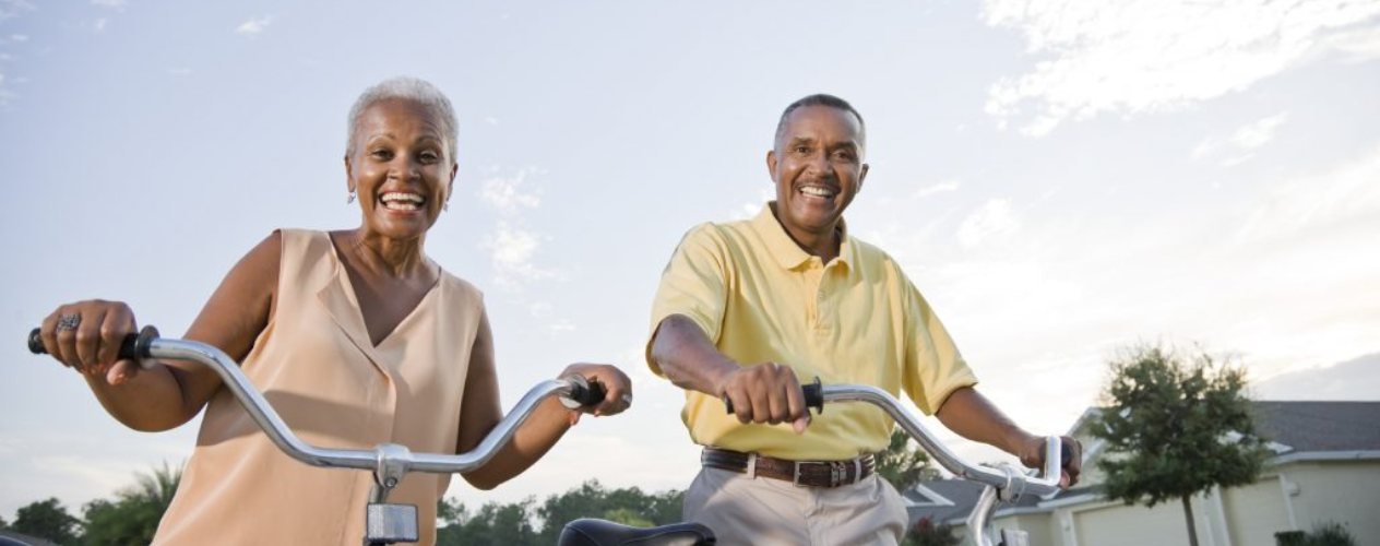 An elderly couple on bikes
