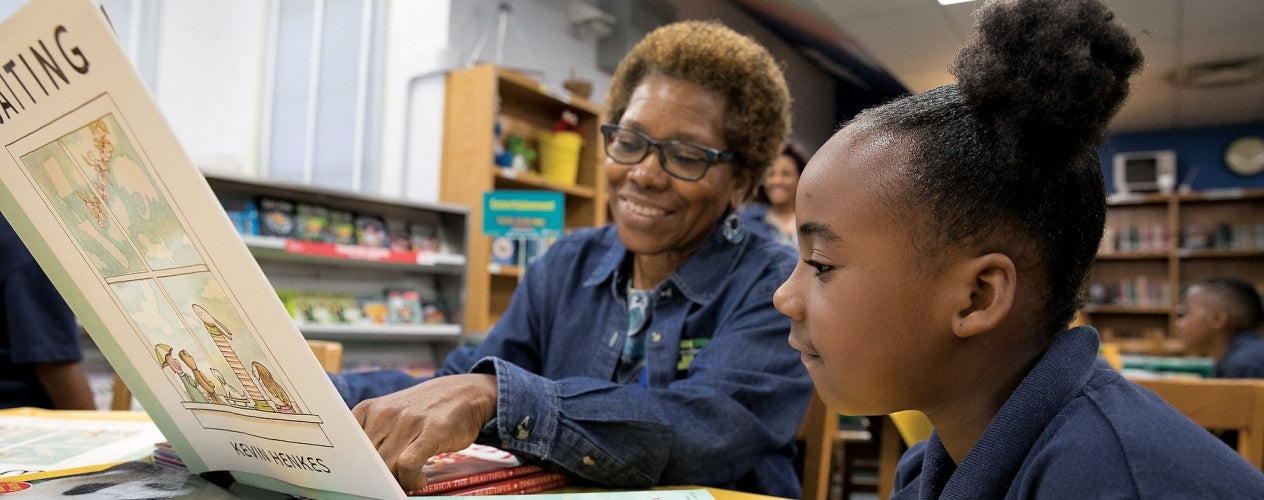 Teacher reading to a student