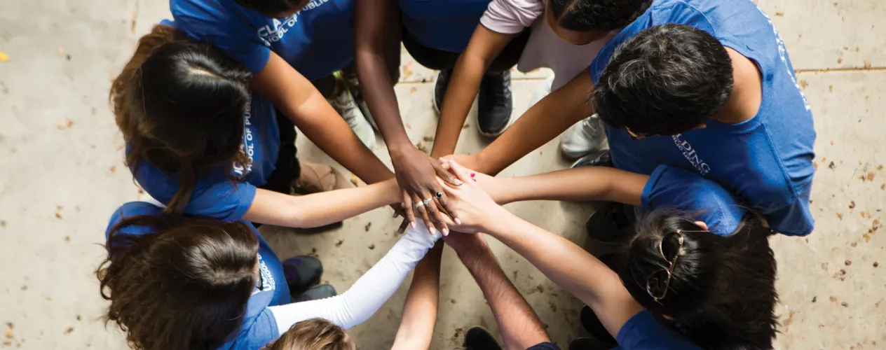 Students putting their hands together