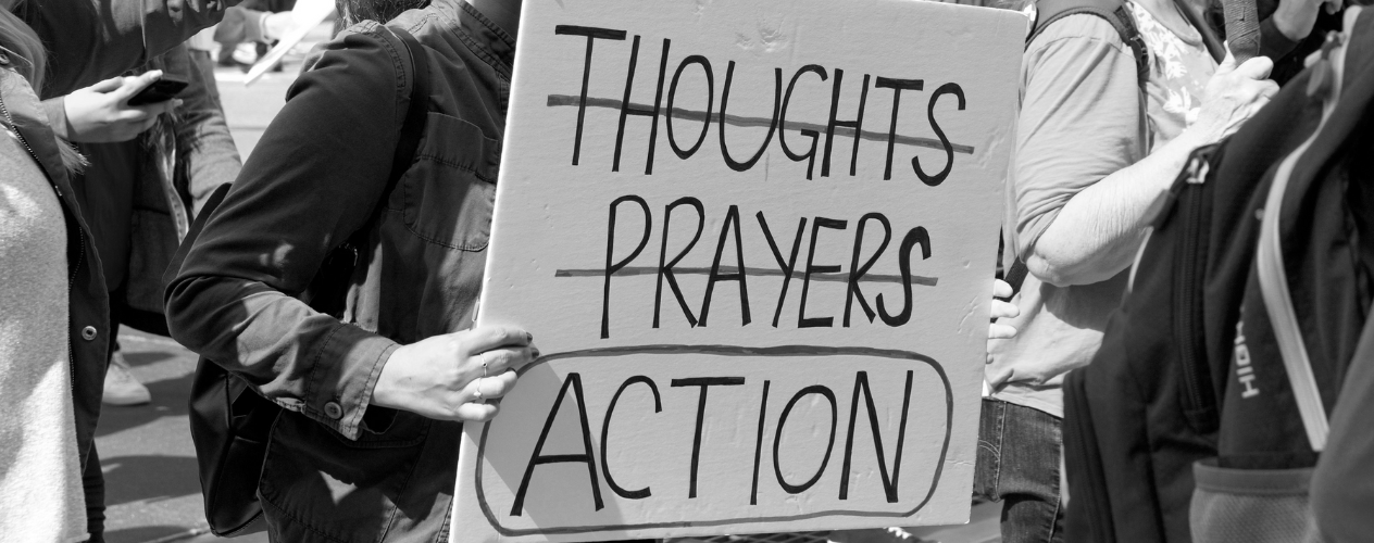 person holding sign with the word action circled