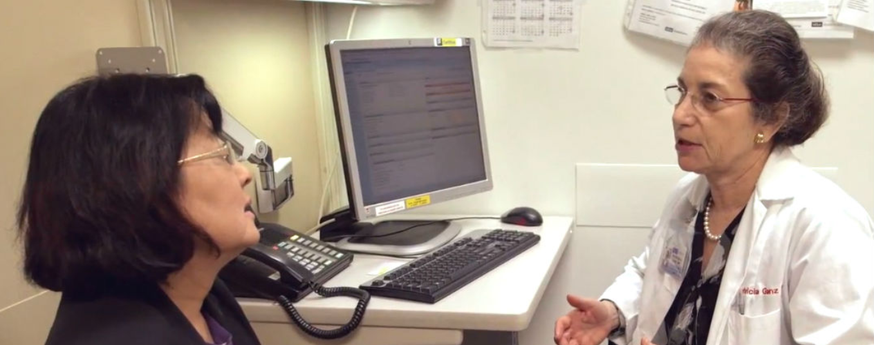 Patricia Ganz talking with patient