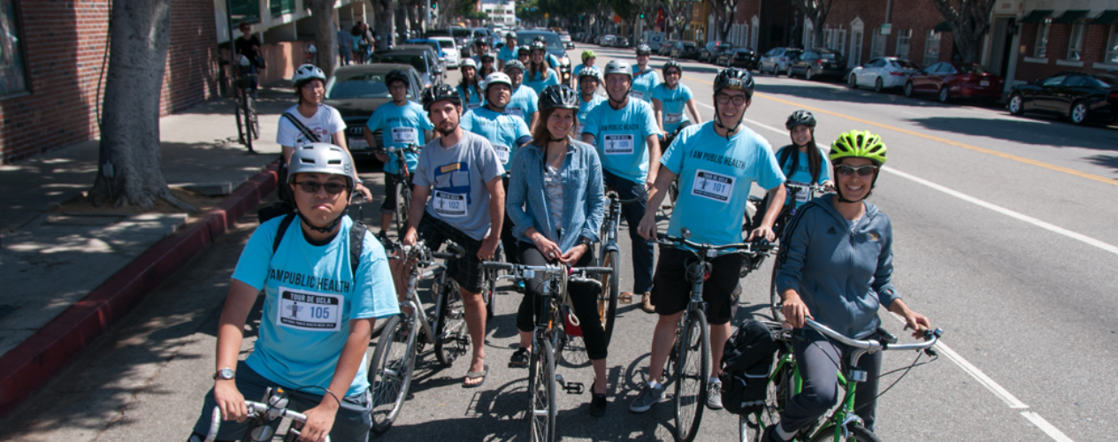 Photo of dozens of Tour de UCLA bike riders at a light in Westwood Village