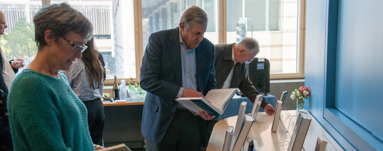 Jean Balgrosky, Jonathan Fielding, Paul Torrens looking at books