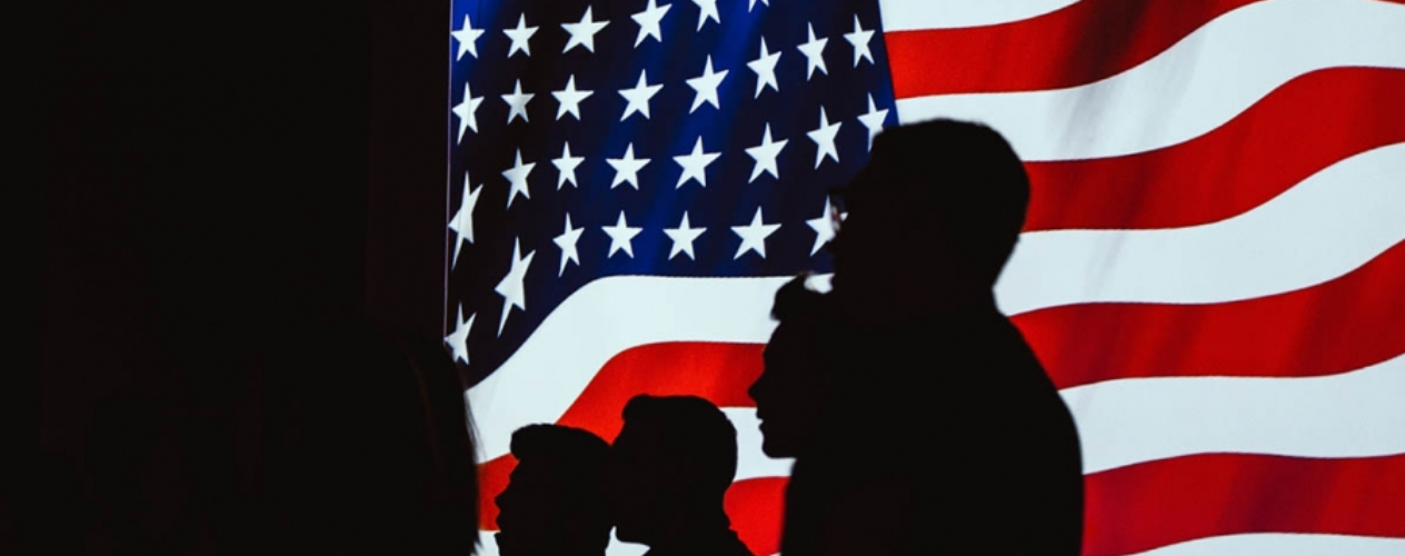 American flag and silhouettes of soldiers