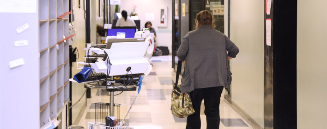 Woman walking in clinic hallway