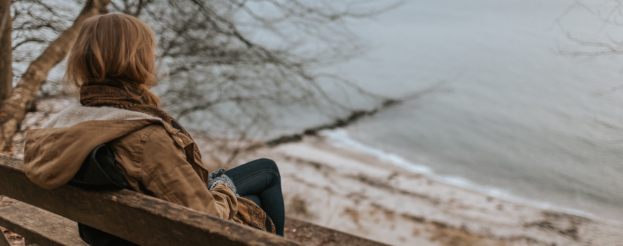 person sitting alone on bench