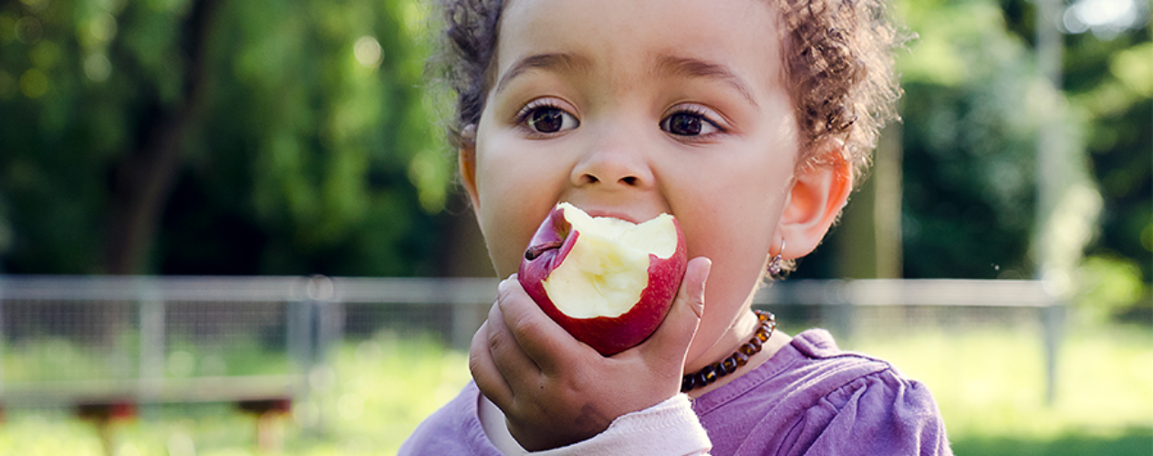 child eating an apple