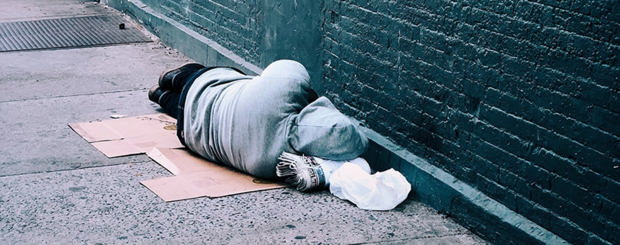 unhoused person lying on the floor