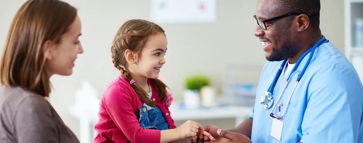 doctor helping young child patient