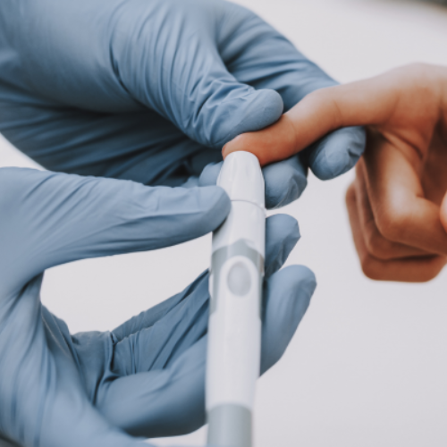 Doctor checking blood sugar levels of patient