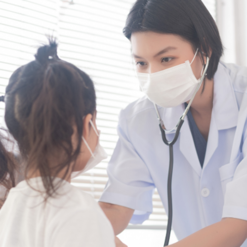 Doctor checking heart rate of young patient