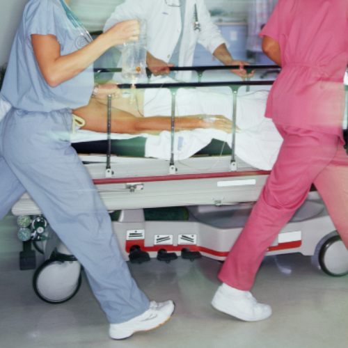 ER doctors rushing a hospital bed