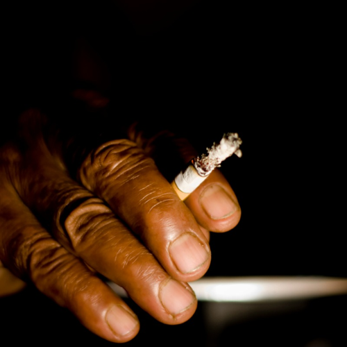 Hand holding a cigarette