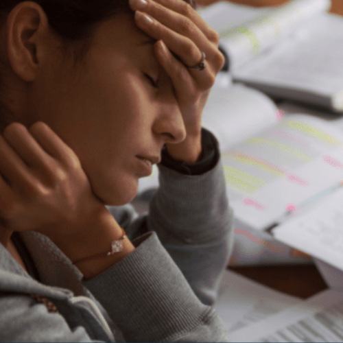 Stressed individual looking at paperwork