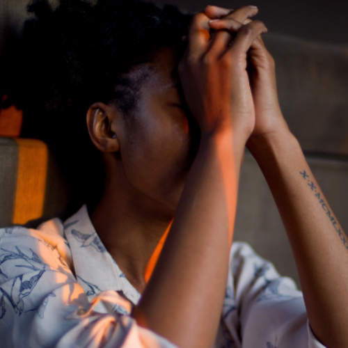 Woman resting head on hands