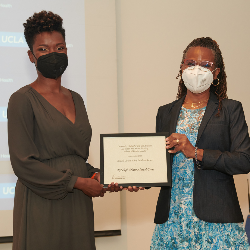 Student accepting an award from a professor