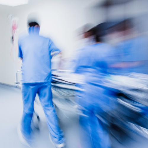 Emergency doctors rushing with operating bed