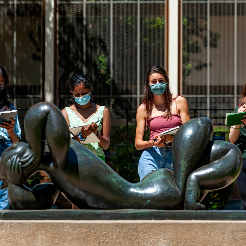 Students studying a statue