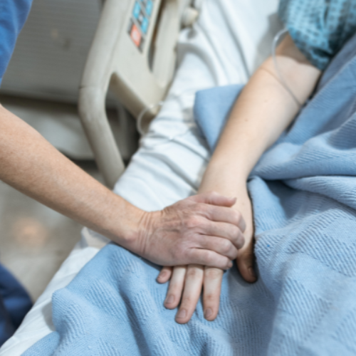 Close-up of doctor holding the hand of a patient