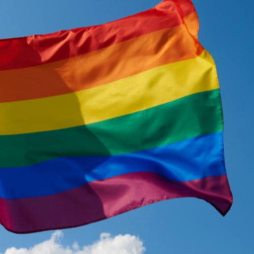 LGBTQ flag waving in sky