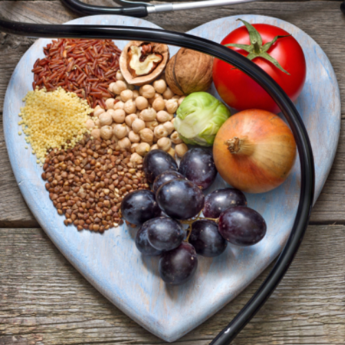 Heart plate with various fruits, nuts, and vegetables
