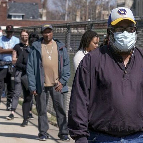 people standing in line to vote