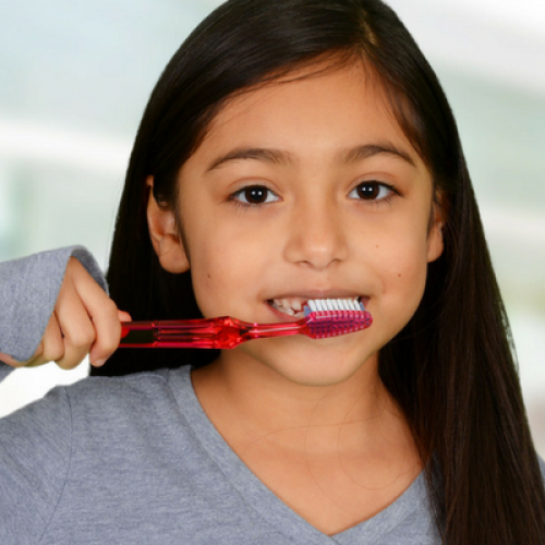 Child brushing her teeth