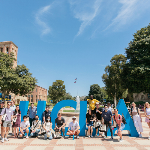 Students standing in front of a UCLA sign