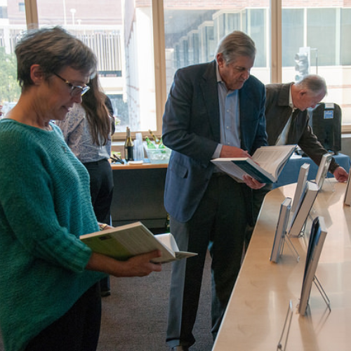 Jean Balgrosky, Jonathan Fielding, Paul Torrens looking at books