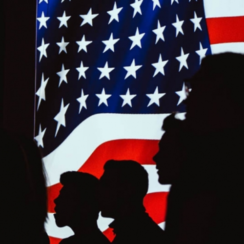 American flag and silhouettes of soldiers