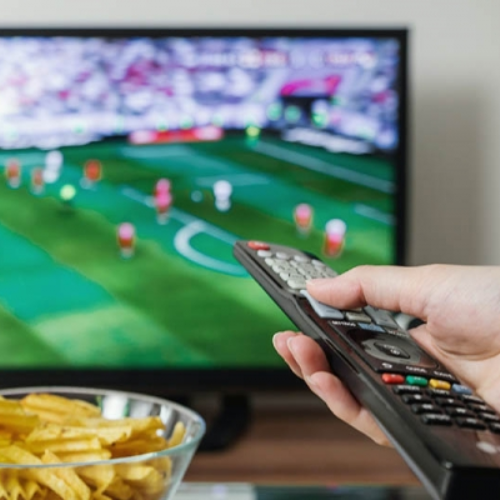 television, remote, and bowl of chips