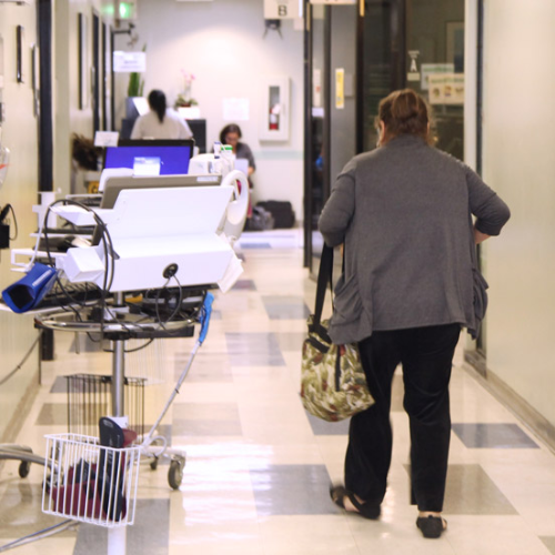 Woman walking in clinic hallway